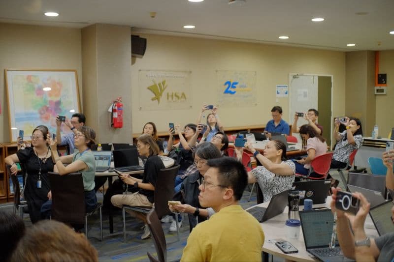 Participants using laptops during the HSA leadership session.